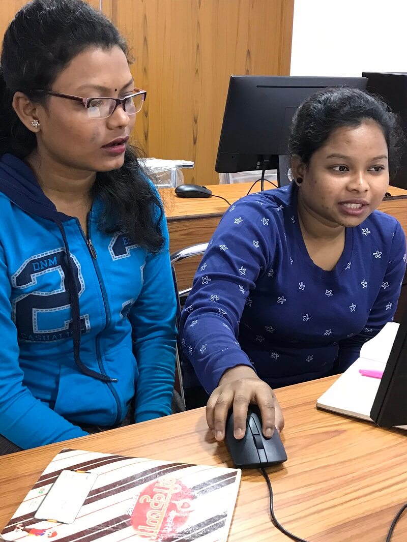 2 students close up on computer